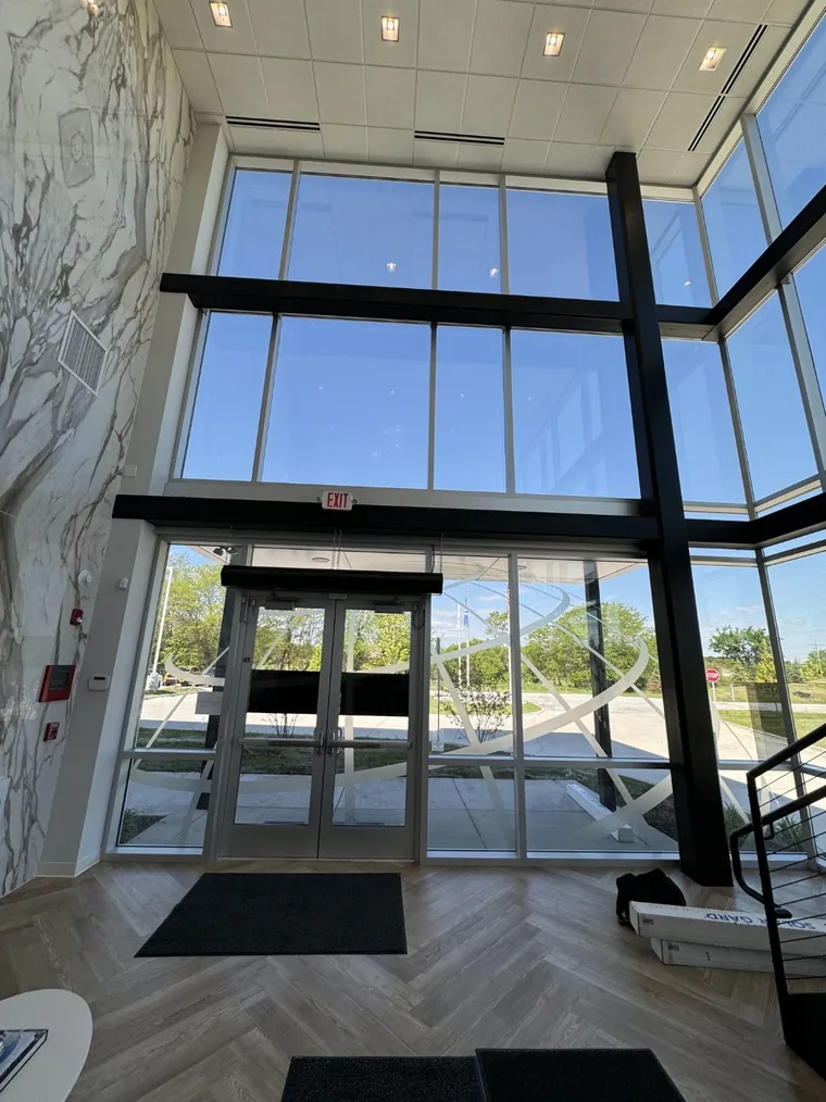 Two-story lobby of the AIT Logistics office with tall windows above the entrance doors.